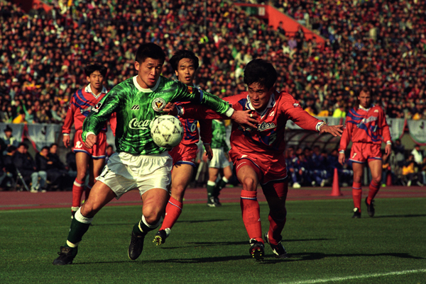 TOKYO, JAPAN - JANUARY 09:  (EDITORIAL USE ONLY) Kazuyoshi Miura of Verdy Kawasaki and Eiji Gaya of Kashima Antlers compete for the ball during the Suntory Championship first leg match between Kashima Antlers and Verdy Kawasaki at the National Stadium on January 9, 1994 in Tokyo, Japan.  (Photo by Etsuo Hara/Getty Images)